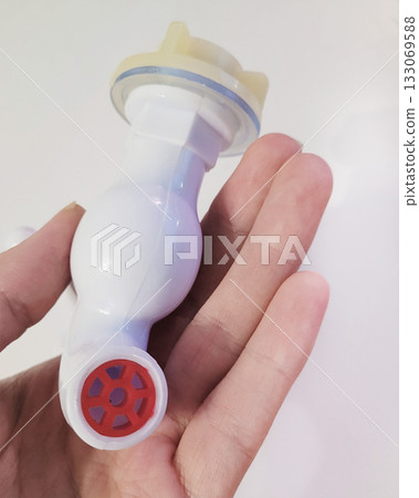 White Plastic Faucet Held in Human Hand White Plastic Faucet Held in Human Hand 133069588
