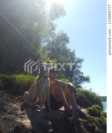Man and Dog Enjoying Sunny Summer Day 133069727