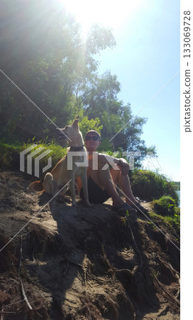 Man and Dog Enjoying Sunny Summer Day 133069728
