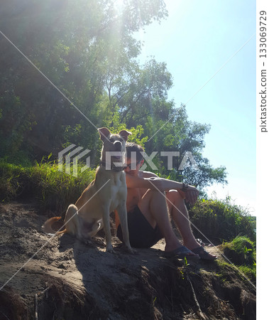 Man and Dog Enjoying Sunny Summer Day 133069729