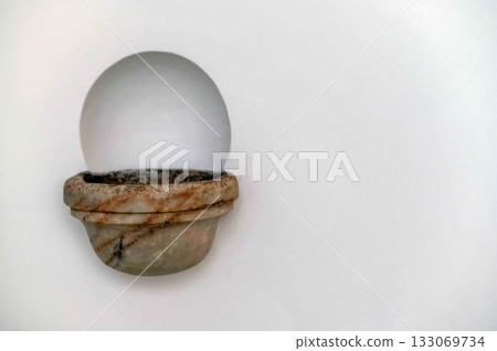 Ancient marble holy water dish on white medieval church wall with copy space Ancient marble holy water dish on white medieval church wall with copy space 133069734