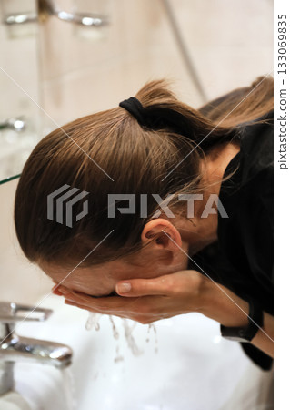 Woman Washing Face In Bathroom Sink Woman Washing Face In Bathroom Sink 133069835