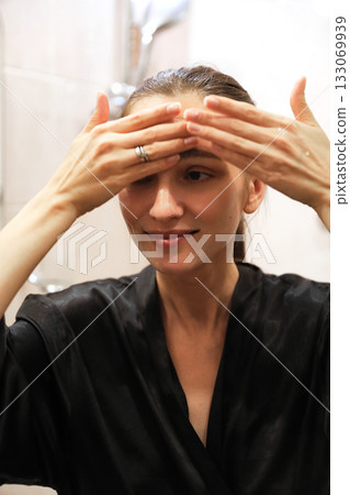 Woman Applying Face Cream, Bathroom Routine Woman Applying Face Cream, Bathroom Routine 133069939