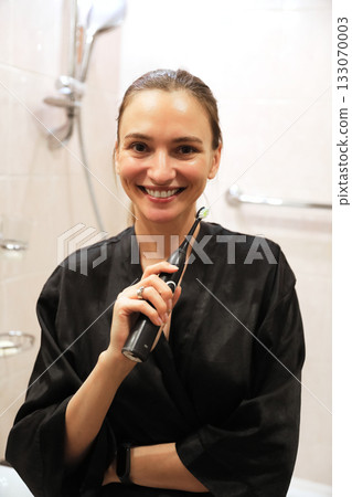 Happy Woman Holding Electric Toothbrush Happy Woman Holding Electric Toothbrush 133070003