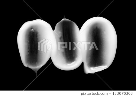 A sample of white body cosmetics on a black background A sample of white body cosmetics on a black background 133070303