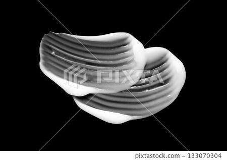 A sample of white body cosmetics on a black background A sample of white body cosmetics on a black background 133070304