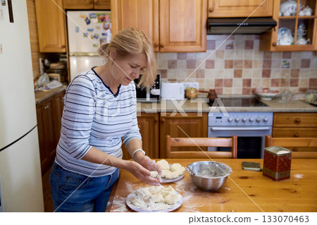Senior Woman Cooking Pancakes at Home Senior Woman Cooking Pancakes at Home 133070463