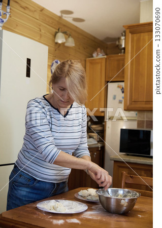 Cheesecakes Preparation: Woman Baking in Cozy Kitchen Cheesecakes Preparation: Woman Baking in Cozy Kitchen 133070690
