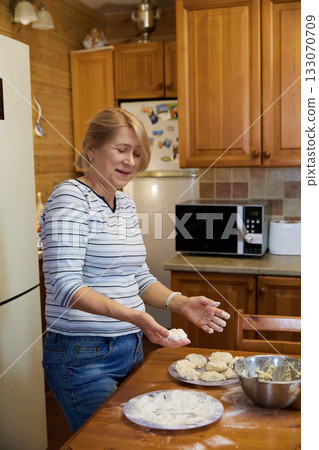 Senior Woman Cooking: Rustic Kitchen and Dough Preparation Senior Woman Cooking: Rustic Kitchen and Dough Preparation 133070709