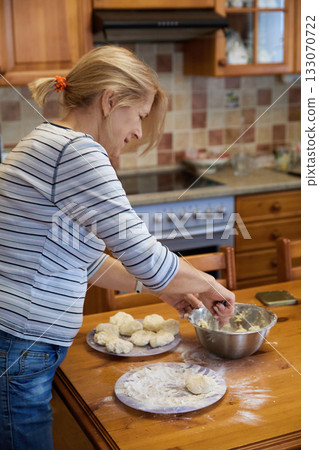 Senior Woman Cooking: Rustic Kitchen and Dough Preparation Senior Woman Cooking: Rustic Kitchen and Dough Preparation 133070722