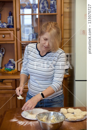 Senior Woman Cooking Pancakes at Home Senior Woman Cooking Pancakes at Home 133070727