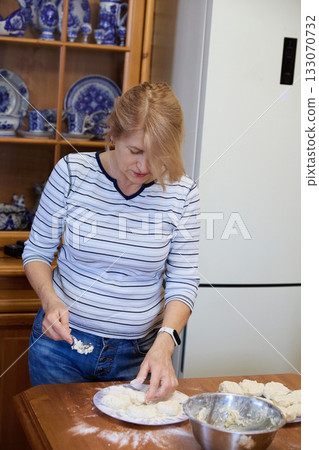 Senior Woman Cooking Pancakes at Home 133070732