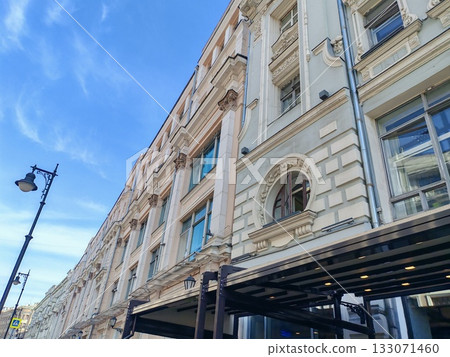 large multi-story building with a classic facade featuring arched windows and modern retail spaces on the ground floor. The blend of traditional architecture and urban commercial life reflects the large multi-story building with a classic facade featuring arched windows and modern retail spaces on the ground floor. The blend of traditional architecture and urban commercial life reflects the 133071460