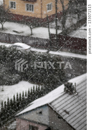 snowing vertical abstract blurred black background. winter abstract vertical blurred black and white. A striking vertical visual of winter 133071515