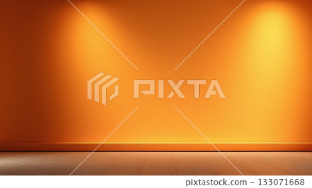A vibrant tangerine wall is softly illuminated by two spotlights, casting a warm glow across the tiled floor, creating a simple yet inviting setting. 133071668