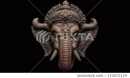 Detailed stone sculpture of an elephant's head on a dark background, showcasing intricate carvings and textures. The sculpture's elaborate headdress adds to its grandeur. Detailed stone sculpture of an elephant's head on a dark background, showcasing intricate carvings and textures. The sculpture's elaborate headdress adds to its grandeur. 133072124