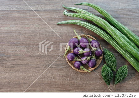 Eggplant, Snake gourd, bitter gourd arranged on wood surface Eggplant, Snake gourd, bitter gourd arranged on wood surface 133073259