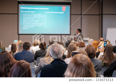 Business conference presentation in a crowded room with a speaker and audience 133073313