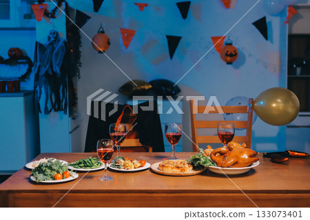 Joyful office Halloween party with coworkers in costumes, celebrating with drinks and laughter, fostering teamwork and festive spirit 133073401