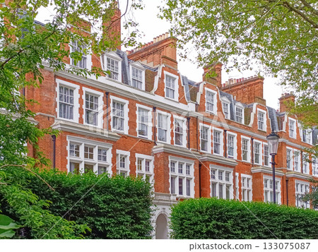 Victorian red brick townhouses in London with sash windows, gables and chimneys 133075087