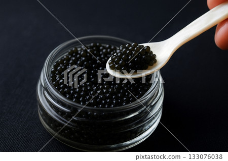 Caviar scooped with a spoon Caviar scooped with a spoon 133076038