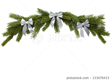 Festive christmas fir garland decorated with elegant silver bows, perfect for holiday background, banner decoration or festive frame element Festive christmas fir garland decorated with elegant silver bows, perfect for holiday background, banner decoration or festive frame element 133076415
