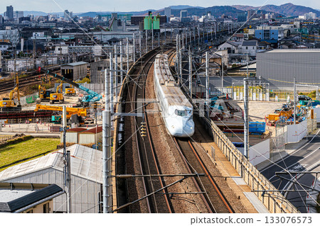 Kyushu Shinkansen Mizuho bound for Shin-Osaka Station. Early winter scenery seen from Shishikan Amusement Park. 1. Higashi Ward, Okayama City, Okayama Prefecture. 133076573