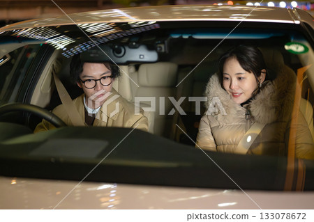 Men and women riding in cars Men and women riding in cars 133078672