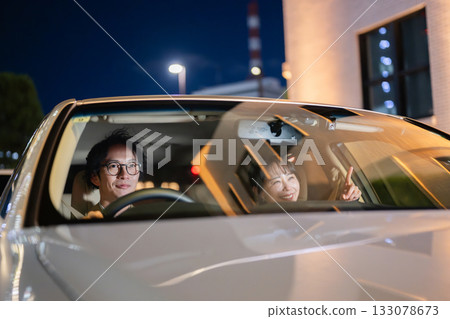Men and women riding in cars 133078673