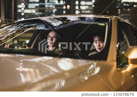 Men and women riding in cars 133078679