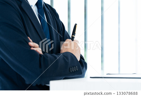 Businessman with arms folded 133078688