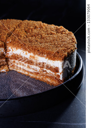 Layered Crumb Cake With Cream Filling On Dark Plate Layered Crumb Cake With Cream Filling On Dark Plate 133079064