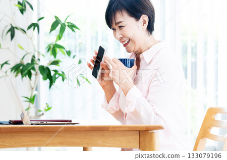 中年婦女在客廳遠程工作 133079196