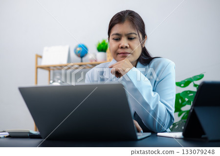 Business Woman Working on Laptop in Office Environment 133079248
