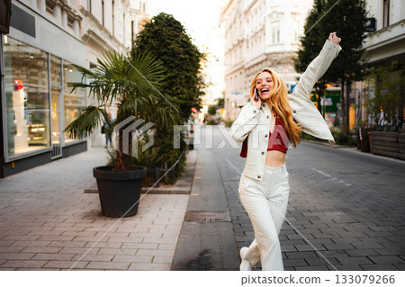 Young woman enjoying phone call walking in Vienna street Young woman enjoying phone call walking in Vienna street 133079266