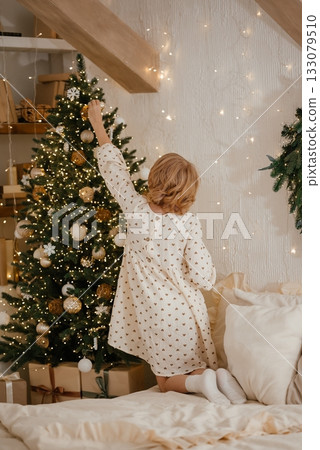 Child Decorating Christmas Tree in Cozy Room Child Decorating Christmas Tree in Cozy Room 133079510