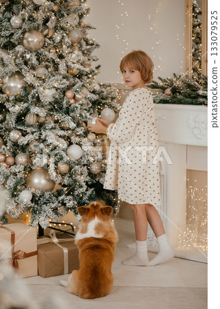 Child and Dog Celebrating Christmas by the Tree Child and Dog Celebrating Christmas by the Tree 133079525