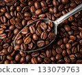 Close-up of roasted coffee beans in a metal spoon 133079763