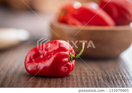 Red chili pepper habanero on wooden table. 133079905