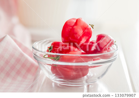Red chili pepper habanero in bowl on white table. Red chili pepper habanero in bowl on white table. 133079907