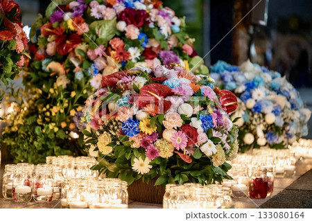 A fantastic flower display of flowers and candles that glow at night 133080164