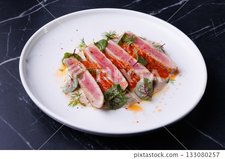 Seared Tuna Steak Slices on Creamy Sauce with Fresh Greens Seared Tuna Steak Slices on Creamy Sauce with Fresh Greens 133080257