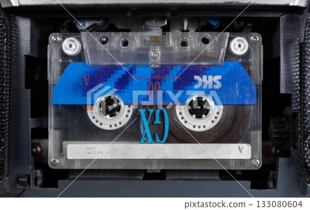 a vintage audio cassette inserted into a tape recorder 133080604