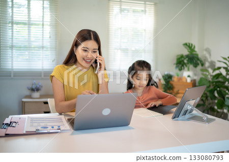 Lovely mom and little young daughter spending time together in their living room. 133080793