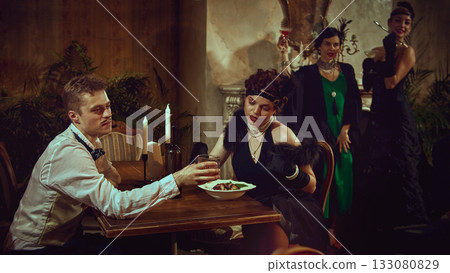 Vintage couple dining with emotional retro mood in elegant restaurant setting 133080829