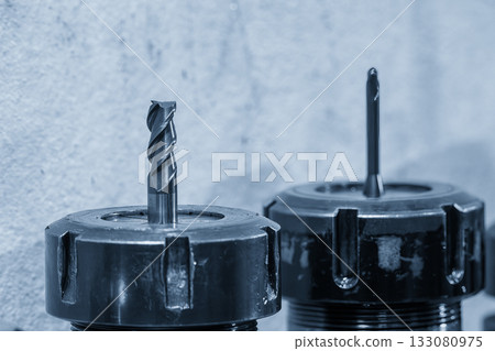 Close-up scene the used flat nose or square shape end mill tools in the blue tone scene. Close-up scene the used flat nose or square shape end mill tools in the blue tone scene. 133080975