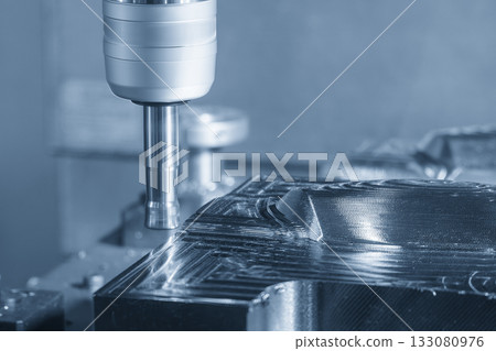 The CNC milling machine rough cutting the injection mold parts by indexable tools in the light blue scene. 133080976