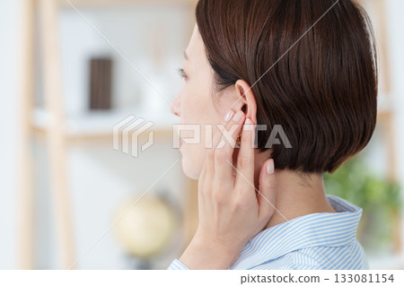 Woman touching her ear (hearing) 133081154