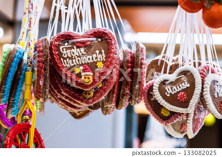 Close up of hanging gingerbread hearts with festive German greeting Frohes Weihnachten Merry Christmas Close up of hanging gingerbread hearts with festive German greeting Frohes Weihnachten Merry Christmas 133082025