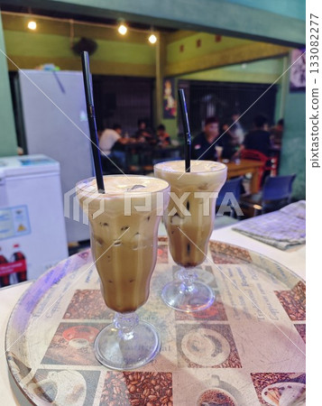 Two Glasses of Iced Coffee with Creamy Topping Two Glasses of Iced Coffee with Creamy Topping 133082277